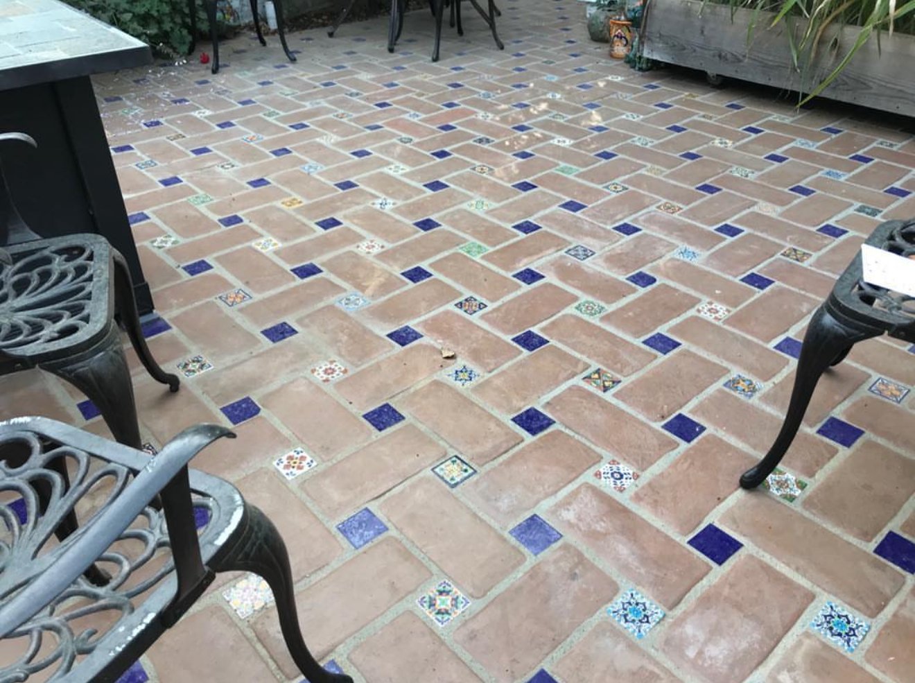 Herringbone clay-brick patio with cobalt and Talavera tile accents